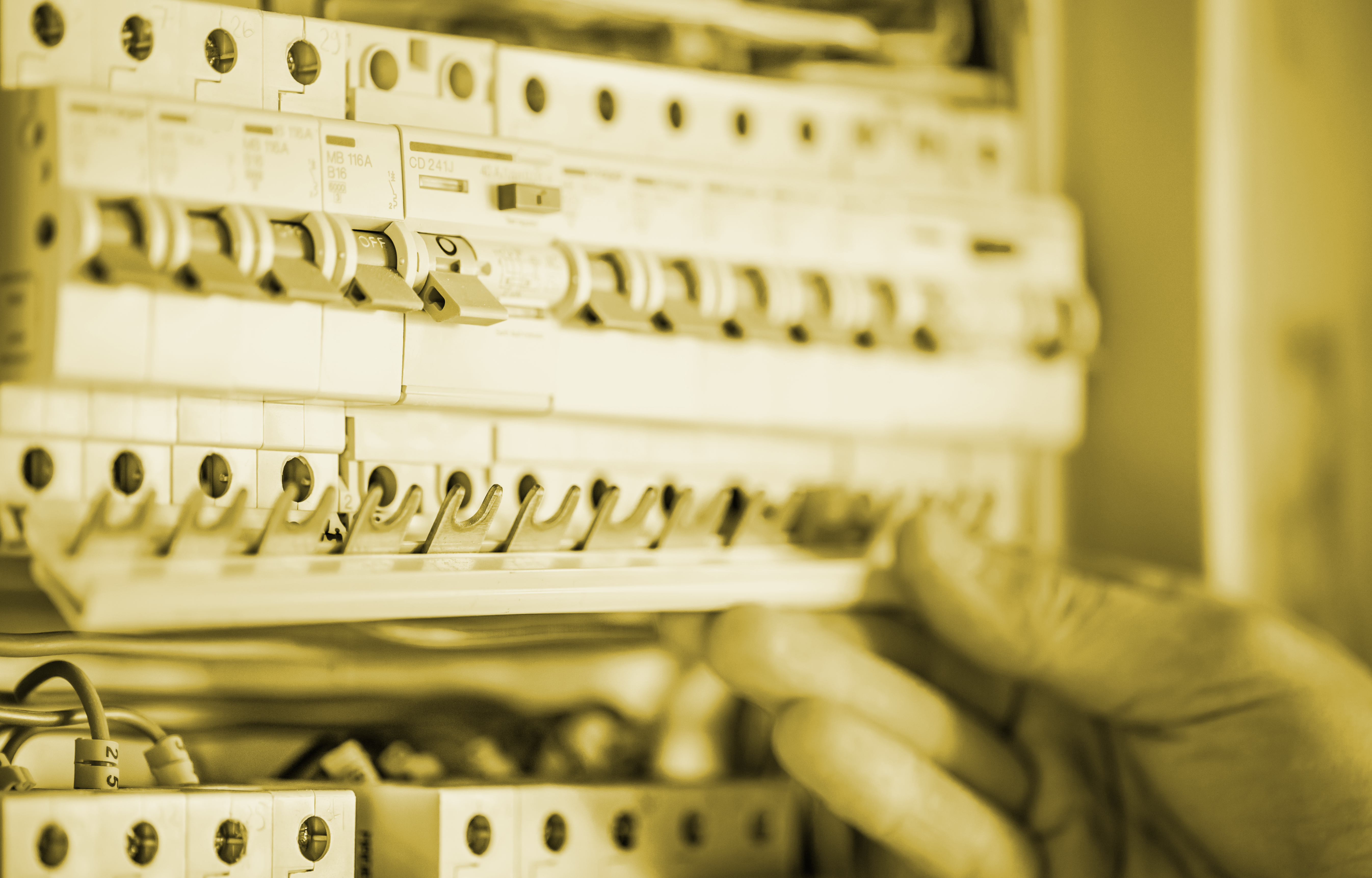 man-an-electrical-technician-working-in-a-switchboard-with-fuses-installation-and-connection-of-electrical-equipment-close-up